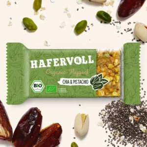 HAFERVOLL Organic Flapjack Chia & Pistachio 60g – Riegel in der Verpackung mit Datteln, Pistazien und Chiasamen