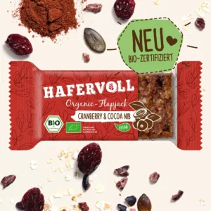 HAFERVOLL Organic Flapjack Cranberry & Cocoa Nib 60g – Riegel in der Verpackung mit Cranberrys und Kakaonibs